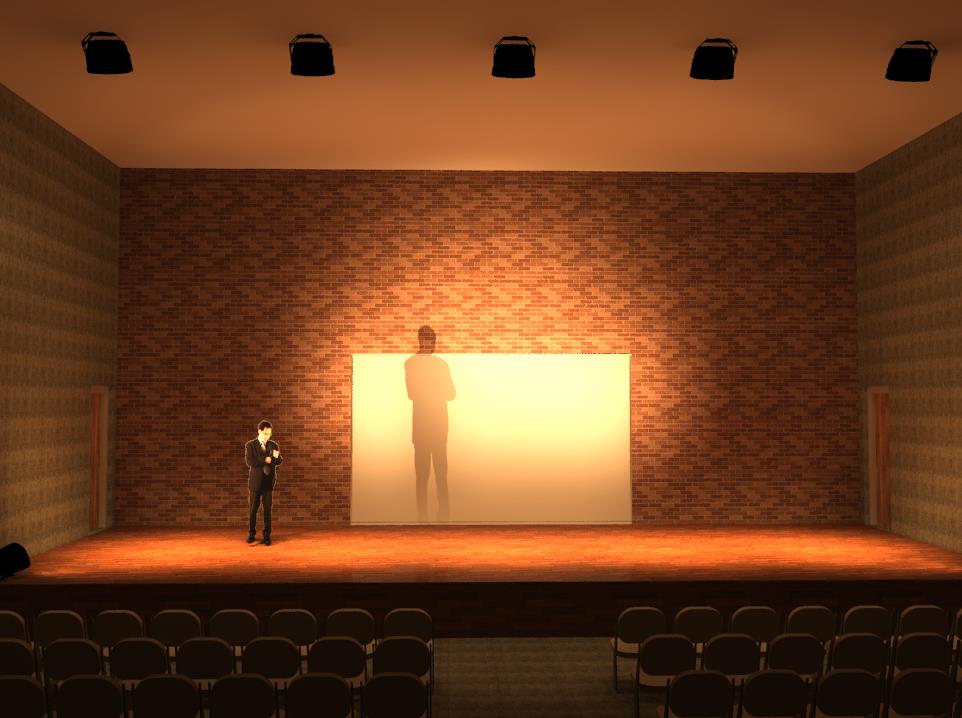 a render of the theater with the stage well-lit and a man standing on it; behind the stage is a row of seats for the audience